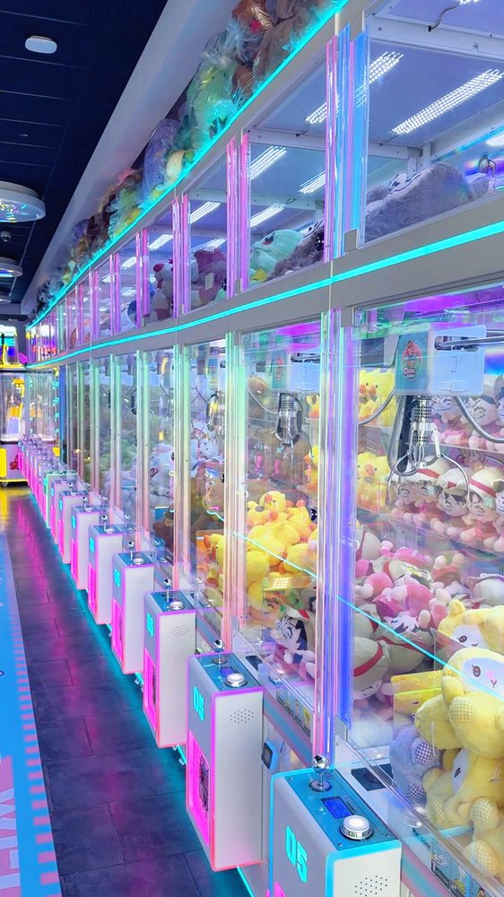 Claw machines packed with colorful plushie prizes