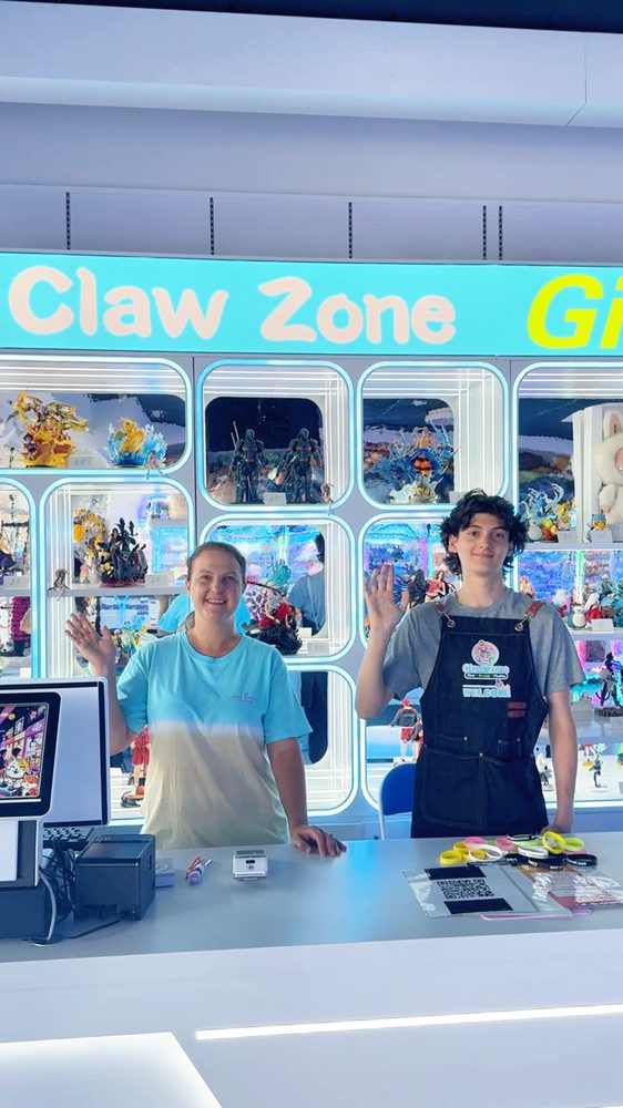 Claw Zone staff waving from the gift counter